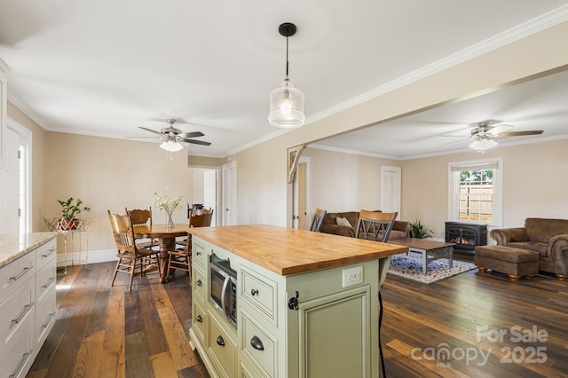 268 Oakland Rd, Spindale, NC 28160 - kitchen featuring butcher block countertops, a ceiling fan, dark wood-style floors, stainless steel microwave, and green cabinets