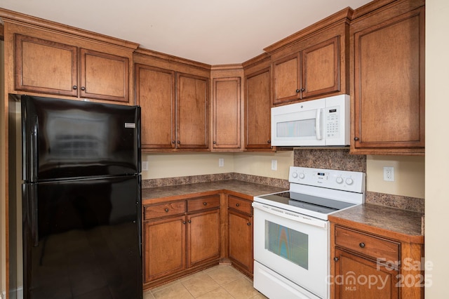 110 Leeper Ave, Belmont, NC 28012 - kitchen featuring white appliances, dark countertops, brown cabinets, and light tile patterned floors