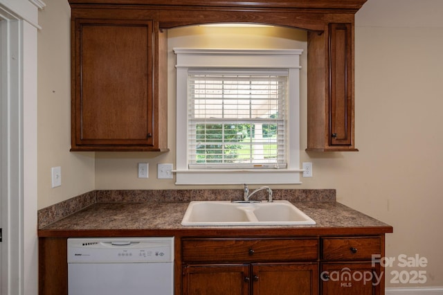 110 Leeper Ave, Belmont, NC 28012 - kitchen with white dishwasher, dark countertops, and brown cabinetry