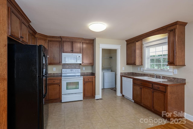 110 Leeper Ave, Belmont, NC 28012 - kitchen with white appliances, separate washer and dryer, dark countertops, and brown cabinets