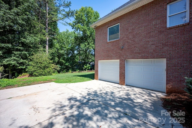 3595 Lake Bluff Dr, Sherrills Ford, NC 28673 - view of home's exterior with concrete driveway, a garage, a yard, and brick siding