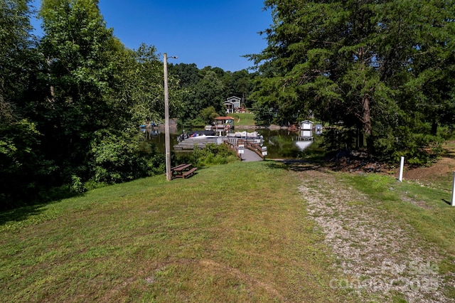 3595 Lake Bluff Dr, Sherrills Ford, NC 28673 - view of grassy yard with a boat dock, a wooded view, and a water view