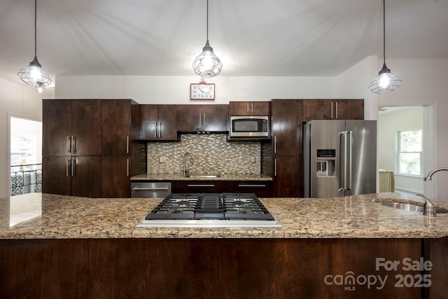 3595 Lake Bluff Dr, Sherrills Ford, NC 28673 - kitchen with appliances with stainless steel finishes, dark brown cabinets, backsplash, and pendant lighting