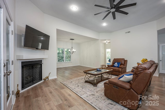 3595 Lake Bluff Dr, Sherrills Ford, NC 28673 - living room featuring a ceiling fan, wood finished floors, a fireplace, a chandelier, and recessed lighting