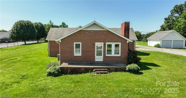 820 Suncrest Orchard Rd, North Wilkesboro, NC 28659 - back of house featuring brick siding, a chimney, a yard, and a detached garage