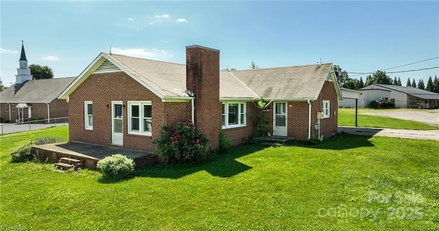 820 Suncrest Orchard Rd, North Wilkesboro, NC 28659 - rear view of property with a chimney, a lawn, brick siding, and roof with shingles
