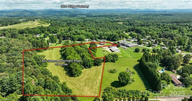 820 Suncrest Orchard Rd, North Wilkesboro, NC 28659 - aerial view of property and surrounding area with property parcel outlined and a forest