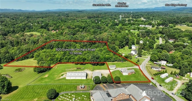 820 Suncrest Orchard Rd, North Wilkesboro, NC 28659 - aerial view of property and surrounding area featuring a heavily wooded area and property boundaries highlighted