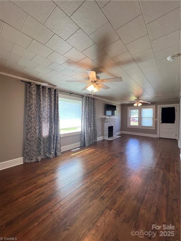 820 Suncrest Orchard Rd, North Wilkesboro, NC 28659 - unfurnished living room with ceiling fan, a fireplace, dark wood-type flooring, and ornamental molding