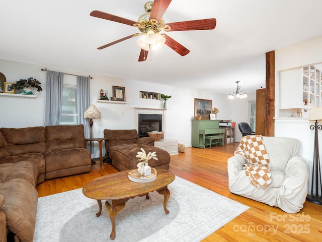 170 Eagle Dr, Salisbury, NC 28144 - living area featuring ceiling fan, wood finished floors, a chandelier, and a fireplace