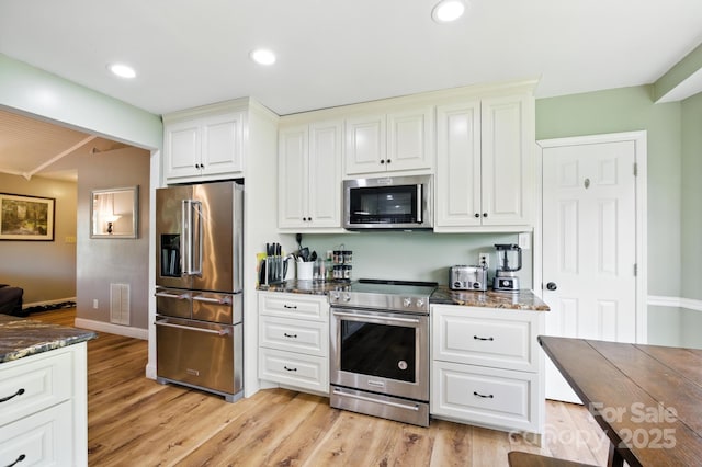 5172 Butner Dr, Hickory, NC 28602 - kitchen with stainless steel appliances, dark stone countertops, light wood-style floors, and recessed lighting