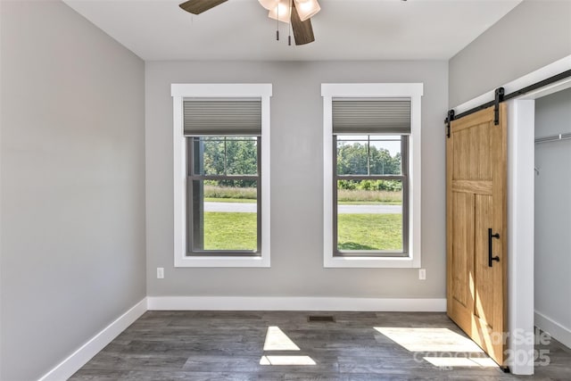 11 S Pine Dr, Weaverville, NC 28787 - spare room with ceiling fan, plenty of natural light, a barn door, and dark wood-style flooring