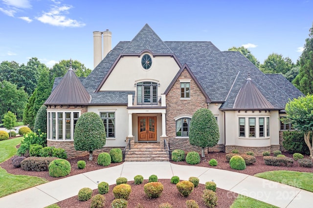 114 Thurstons Way, Mooresville, NC 28117 - view of front facade featuring a standing seam roof, stucco siding, stone siding, and french doors