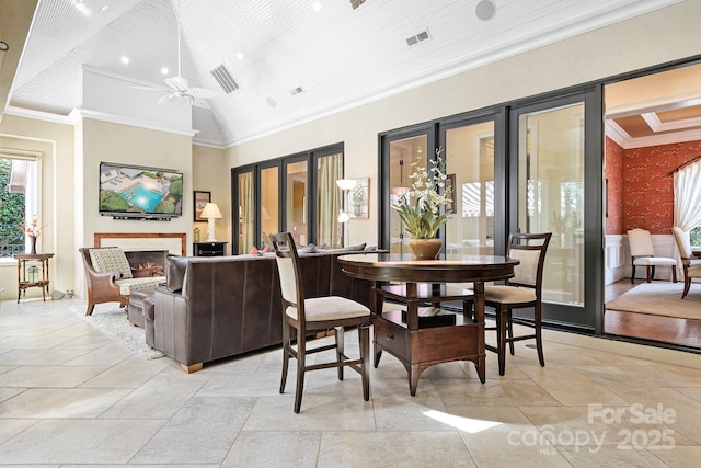 114 Thurstons Way, Mooresville, NC 28117 - dining area with a warm lit fireplace, crown molding, and wooden ceiling