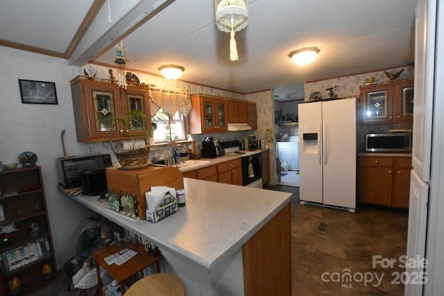 4854 Elk Ct, Morganton, NC 28655 - kitchen featuring white refrigerator with ice dispenser, stainless steel microwave, range with electric stovetop, brown cabinets, and crown molding