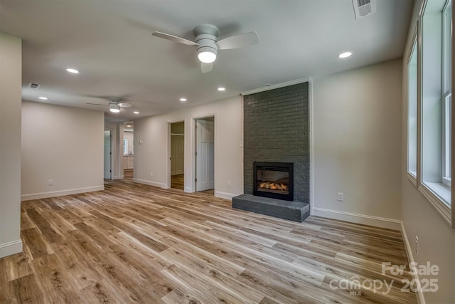 835 Vine Arden Rd, Morganton, NC 28655 - unfurnished living room with a ceiling fan, a brick fireplace, light wood finished floors, and recessed lighting