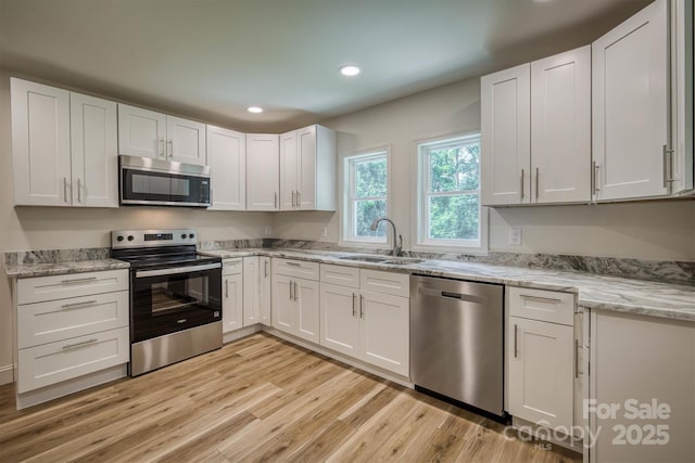 835 Vine Arden Rd, Morganton, NC 28655 - kitchen featuring appliances with stainless steel finishes, light wood finished floors, white cabinetry, recessed lighting, and light stone countertops