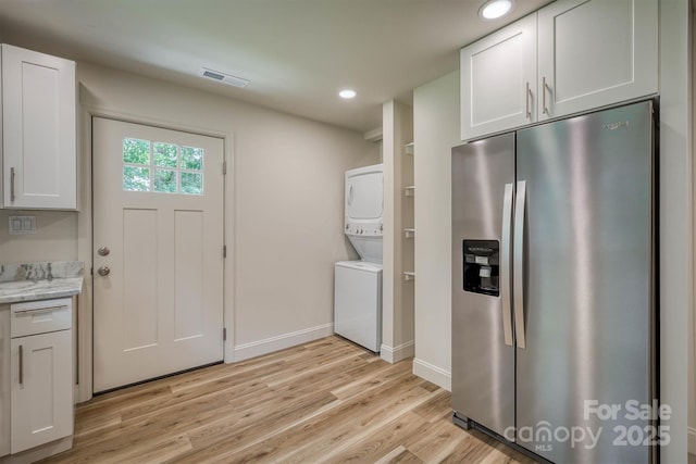 835 Vine Arden Rd, Morganton, NC 28655 - laundry room with stacked washer / drying machine, light wood-style flooring, and recessed lighting
