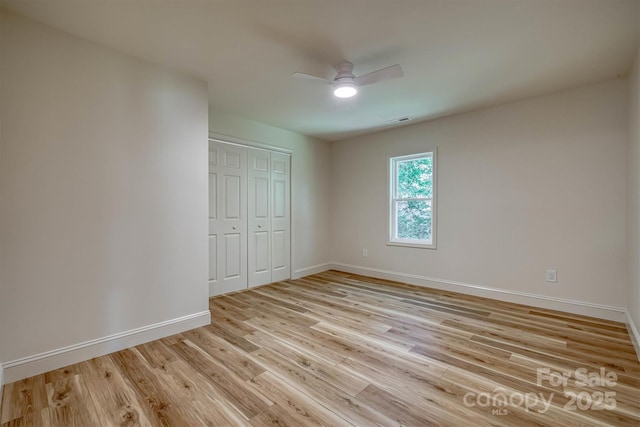 835 Vine Arden Rd, Morganton, NC 28655 - unfurnished bedroom with a closet, light wood-style flooring, and ceiling fan