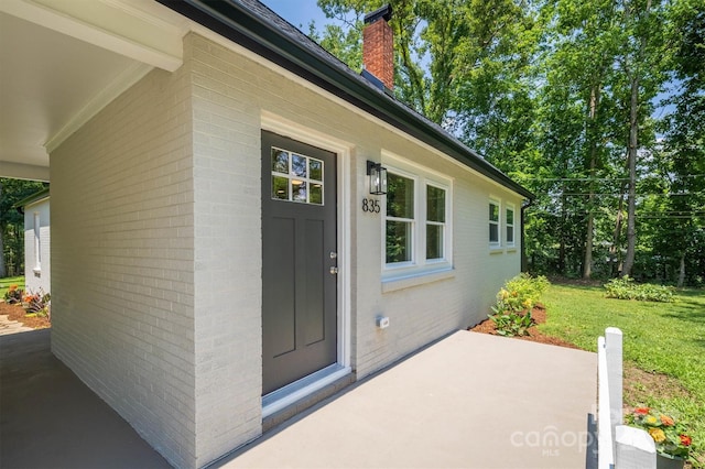 835 Vine Arden Rd, Morganton, NC 28655 - property entrance with brick siding, a chimney, and a patio area