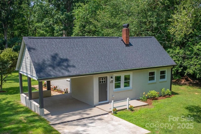 835 Vine Arden Rd, Morganton, NC 28655 - view of front of house with a shingled roof, a chimney, an attached carport, a front yard, and concrete driveway