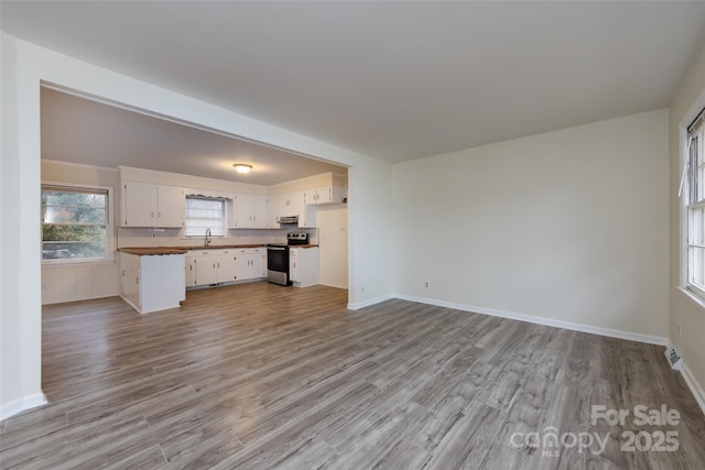 4601 Mendham Dr, Charlotte, NC 28215 - unfurnished living room featuring light wood-type flooring