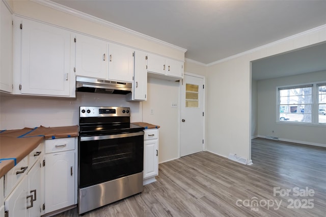 4601 Mendham Dr, Charlotte, NC 28215 - kitchen with stainless steel electric range, extractor fan, light wood finished floors, crown molding, and white cabinets