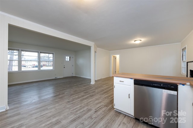 4601 Mendham Dr, Charlotte, NC 28215 - kitchen with stainless steel dishwasher, white cabinetry, light wood-style floors, crown molding, and open floor plan
