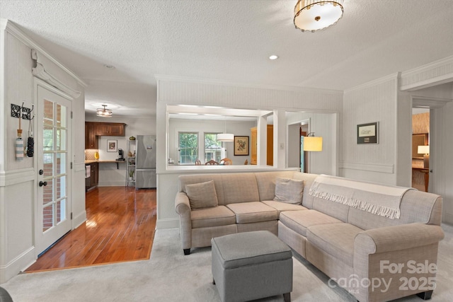 747 9th St NW, Hickory, NC 28601 - living area with crown molding, light wood-style flooring, and a textured ceiling