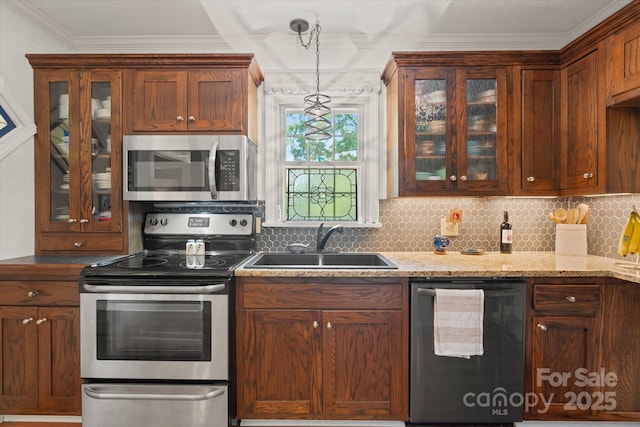 747 9th St NW, Hickory, NC 28601 - kitchen featuring stainless steel appliances, crown molding, glass insert cabinets, decorative light fixtures, and tasteful backsplash