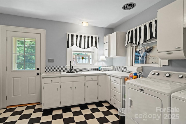 747 9th St NW, Hickory, NC 28601 - laundry area with washing machine and dryer, cabinet space, and light floors