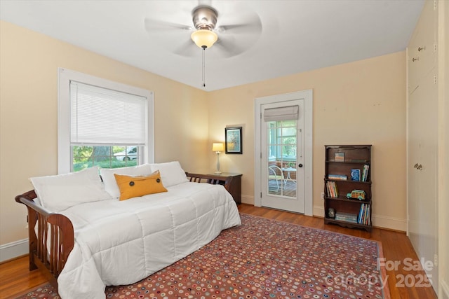 747 9th St NW, Hickory, NC 28601 - bedroom with multiple windows, wood finished floors, and a ceiling fan