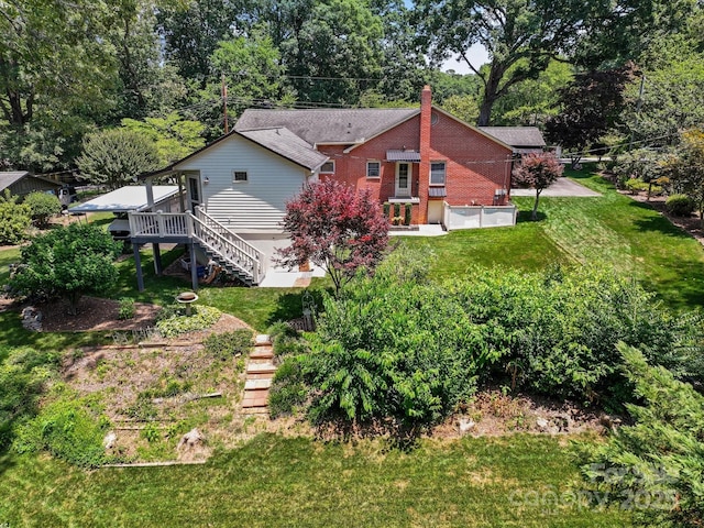 747 9th St NW, Hickory, NC 28601 - back of house with stairway, a lawn, and view of scattered trees