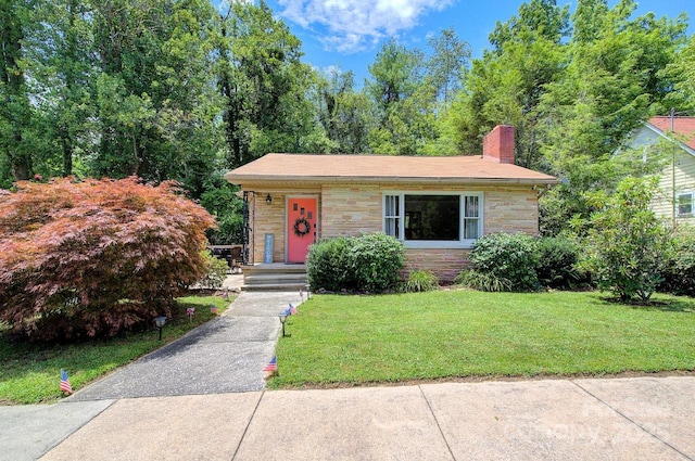 207 Buncombe St, Hendersonville, NC 28739 - view of front of property featuring stone siding, a front yard, and a chimney
