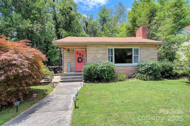 207 Buncombe St, Hendersonville, NC 28739 - view of front of house with stone siding, a front lawn, and a chimney