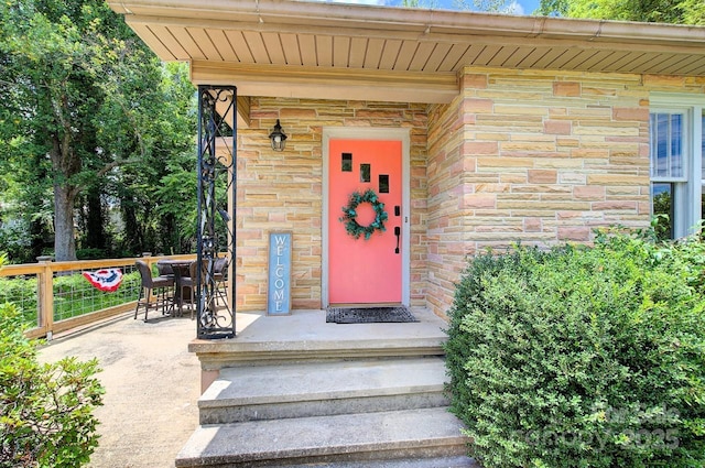 207 Buncombe St, Hendersonville, NC 28739 - view of exterior entry featuring stone siding and outdoor dining area