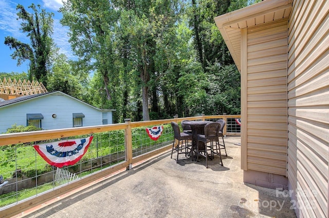 207 Buncombe St, Hendersonville, NC 28739 - view of patio featuring outdoor dining area and view of wooded area