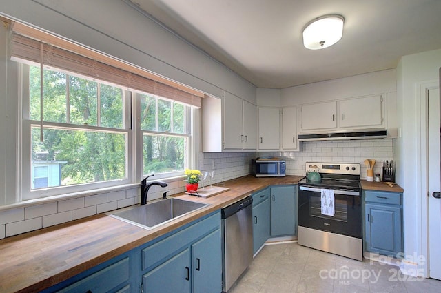 207 Buncombe St, Hendersonville, NC 28739 - kitchen featuring wooden counters, blue cabinetry, stainless steel appliances, and healthy amount of natural light