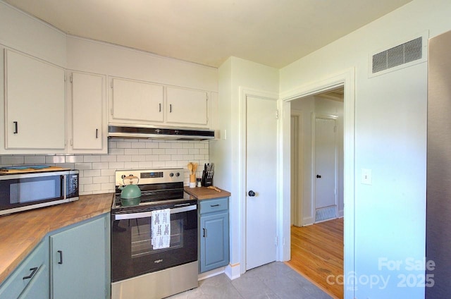 207 Buncombe St, Hendersonville, NC 28739 - kitchen featuring stainless steel appliances, butcher block counters, tasteful backsplash, white cabinetry, and ventilation hood