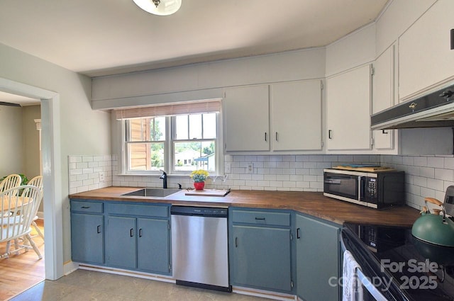 207 Buncombe St, Hendersonville, NC 28739 - kitchen featuring wood counters, stainless steel dishwasher, electric range oven, blue cabinetry, and tasteful backsplash