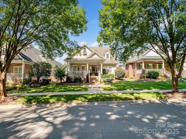 5572 Yorke St NW, Concord, NC 28027 - view of front of home with a porch, brick siding, and a front lawn