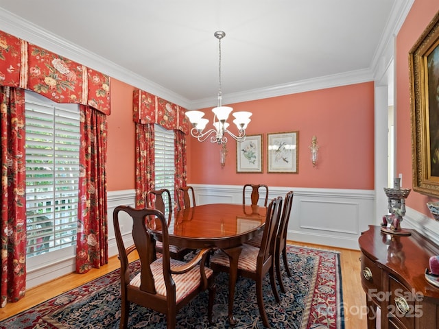 5572 Yorke St NW, Concord, NC 28027 - dining area featuring a chandelier, wood finished floors, crown molding, and a wainscoted wall