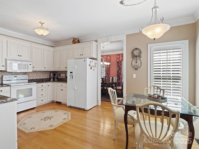 5572 Yorke St NW, Concord, NC 28027 - kitchen with white appliances, crown molding, light wood-style flooring, white cabinets, and decorative light fixtures