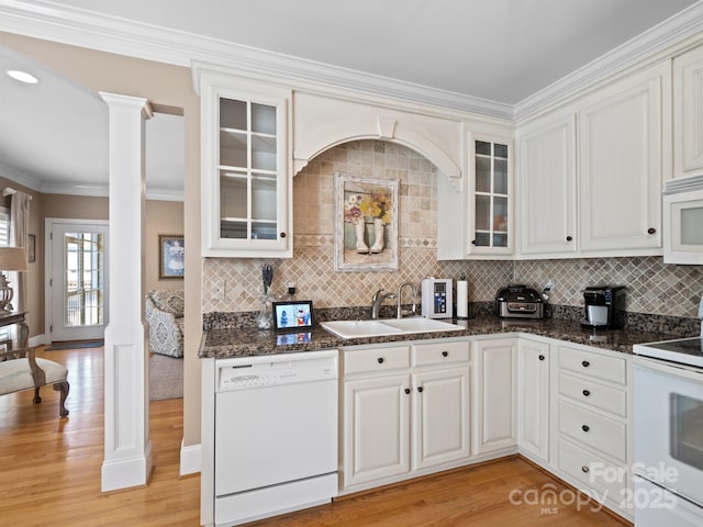5572 Yorke St NW, Concord, NC 28027 - kitchen with white appliances, decorative columns, ornamental molding, backsplash, and light wood-type flooring