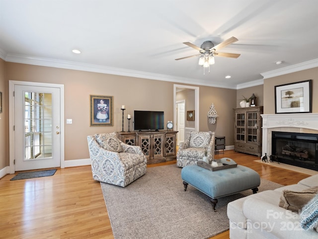 5572 Yorke St NW, Concord, NC 28027 - living area featuring light wood finished floors, a ceiling fan, crown molding, a fireplace with flush hearth, and recessed lighting