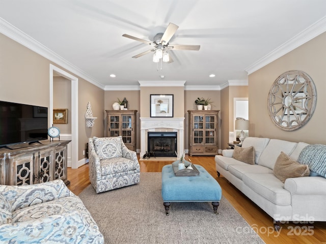 5572 Yorke St NW, Concord, NC 28027 - living area with a ceiling fan, recessed lighting, light wood-type flooring, ornamental molding, and a fireplace with flush hearth