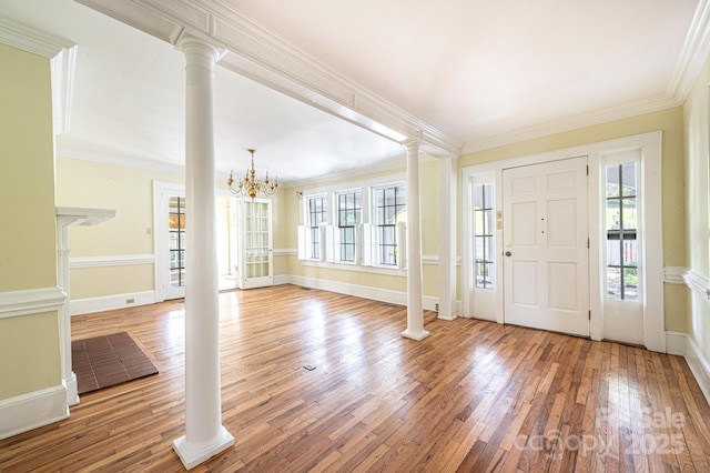 1010 College Ave SW, Lenoir, NC 28645 - entrance foyer featuring ornate columns, healthy amount of natural light, hardwood / wood-style floors, a chandelier, and ornamental molding
