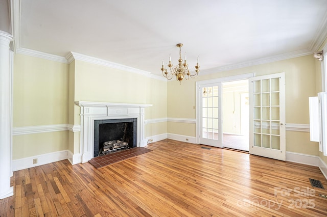 1010 College Ave SW, Lenoir, NC 28645 - unfurnished living room with light wood-style floors, a chandelier, a tile fireplace, ornamental molding, and french doors