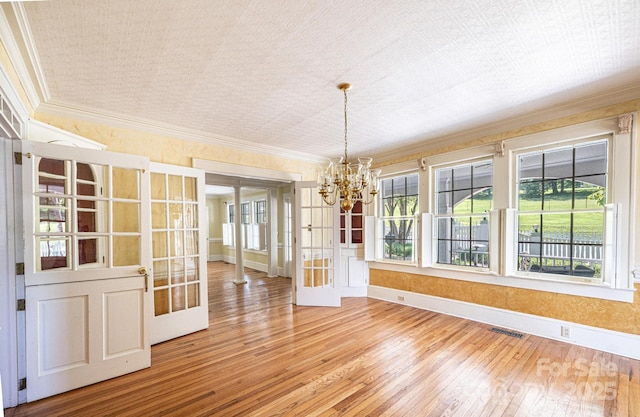 1010 College Ave SW, Lenoir, NC 28645 - unfurnished dining area with french doors, ornamental molding, a chandelier, and wood-type flooring