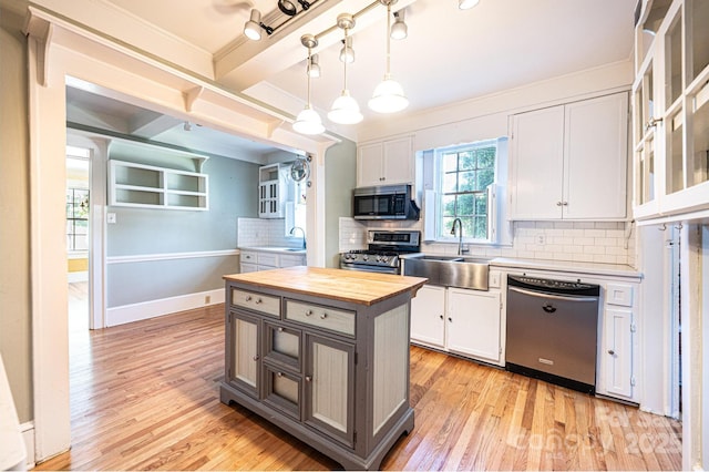 1010 College Ave SW, Lenoir, NC 28645 - kitchen featuring appliances with stainless steel finishes, wood counters, light wood-style flooring, tasteful backsplash, and white cabinetry
